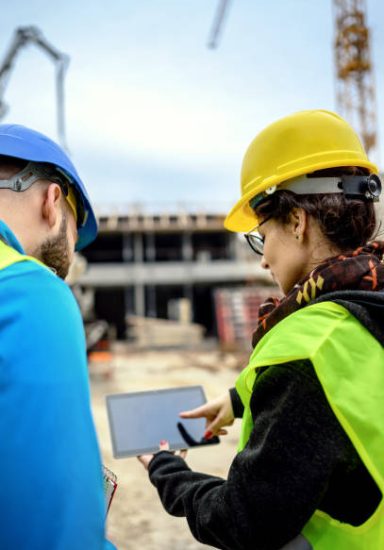 Construction workers Using Digital Tablet on a construction site
