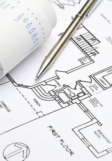 Pen and calculator tape on blueprints. Concept for home improvement costs.